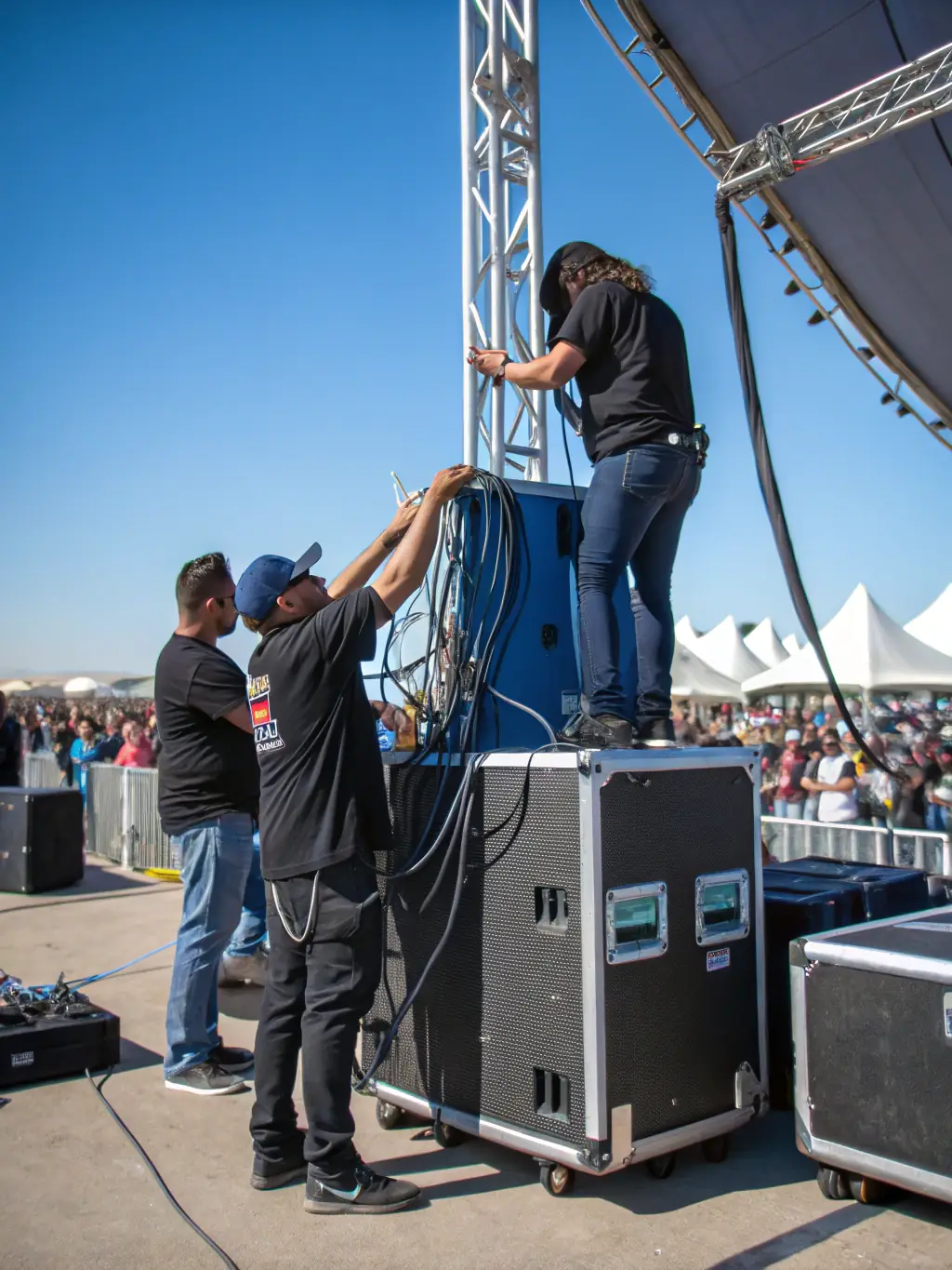 A behind-the-scenes photo of BANDE DU PARADOU's team setting up for an event, showcasing their technical expertise and dedication to creating high-quality live performance experiences.
