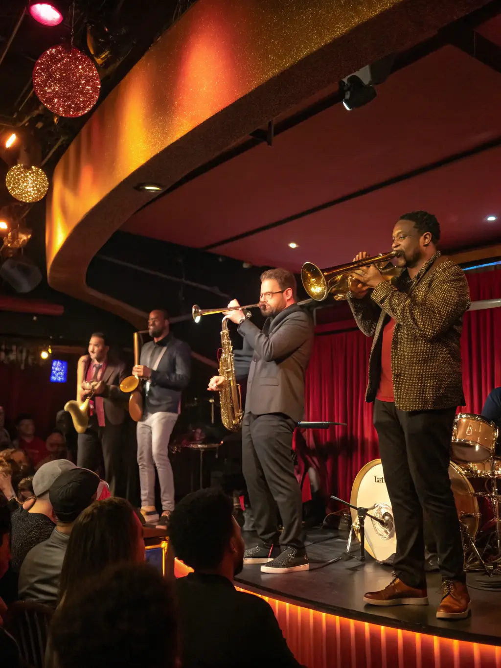 A photograph capturing the vibrant atmosphere of a past BANDE DU PARADOU event, featuring a jazz band performing on stage with a lively audience in the background, showcasing the energy and excitement of the performance.